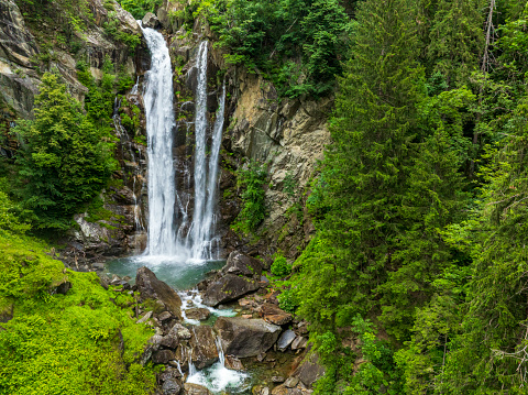 Cascata di Valclava or Kalmtaler Wasserfall or Passeier wasserfall waterfall in South Tirol, Italy during a beautiful springtime day in the Alps. The river Kalmbach is falling down in the midst of a dense forest