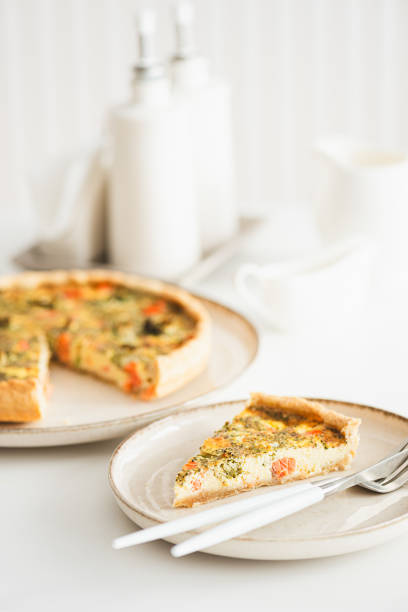 istock French quiche lauren with salmon, cheese and broccoli on white table. Soft focus 2077823157