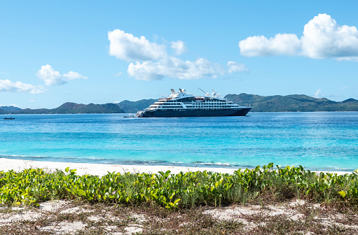 Aride Island, Seychelles - April 4, 2023: Cruise ship Le Jacques-Cartier of Ponant Cruises in the Seychelles at the beach of Aride Island. Side view of expedition cruise ship.