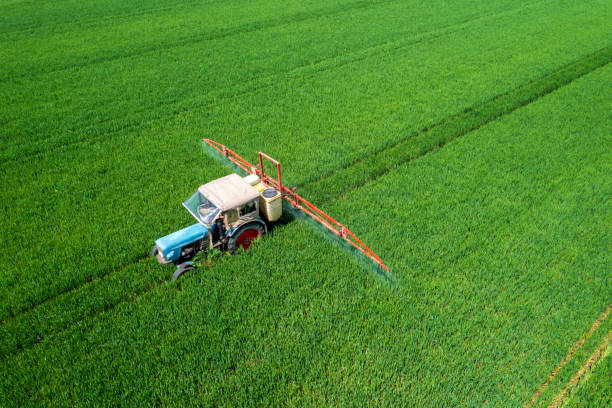 istock Tractor fertilizing a field, aerial view 2077833566
