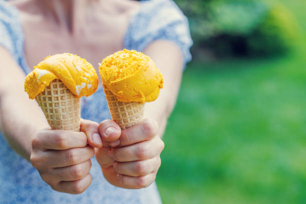 Refreshing ice cream in waffle cones with lemon flavour