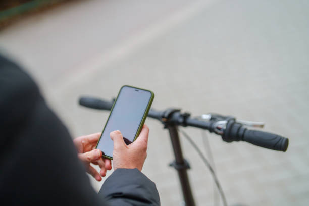 istock Woman using mobile phone on bike. 2077884376