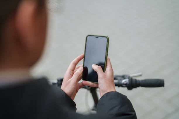 istock Woman using mobile phone on bike. 2077894853