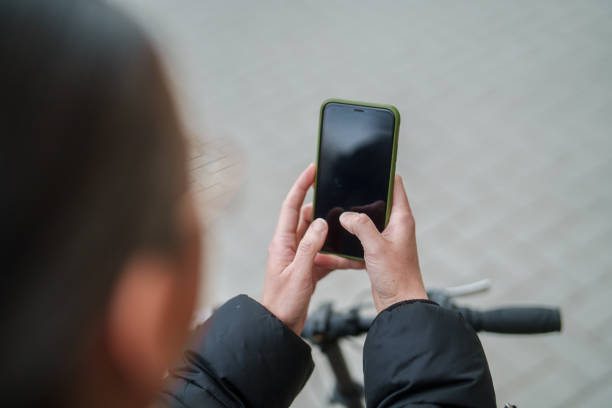 istock Woman using mobile phone on bike. 2077894854