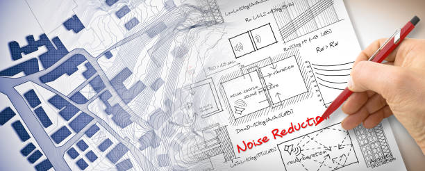 istock Engineer writing formulas about noise reduction in buildings - concept image with city map 2077895371