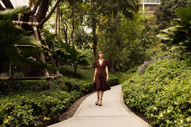 istock Young Asian woman walking during springtime in the park. 2077895378