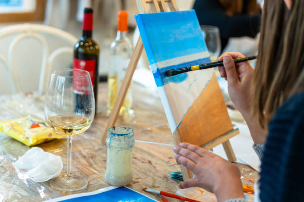 istock Art and Wine workshop. Middle aged woman learning to paint. 2077898691