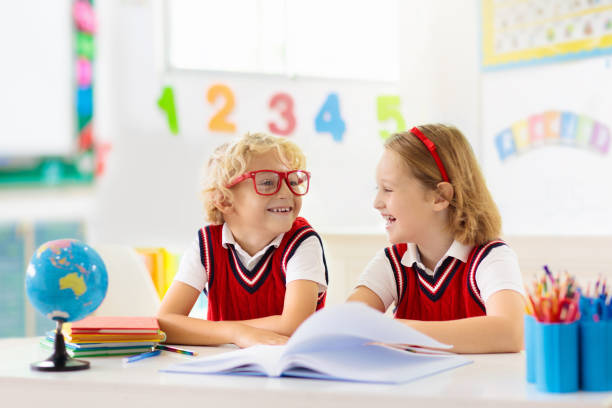 Kids go back to school. Children study and learn for preschool. Boy and girl of elementary class doing homework. Bedroom with desk, books and globe for young child. Kid learning to read and write.