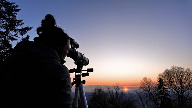 istock Amateur astronomer observing Sun eclipse and Sun with a telescope and special solar filter. 2077916662