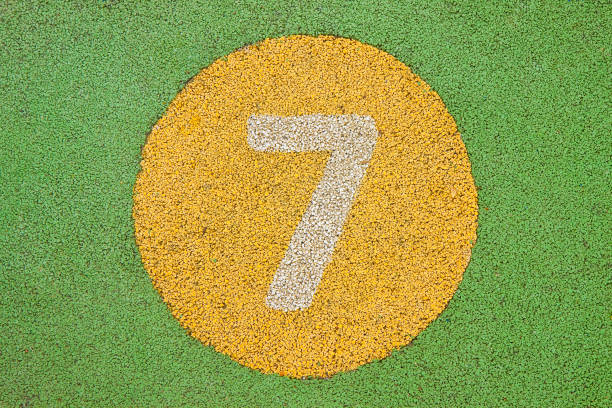 Number seven in a multicolored rubber outdoors children's playground.