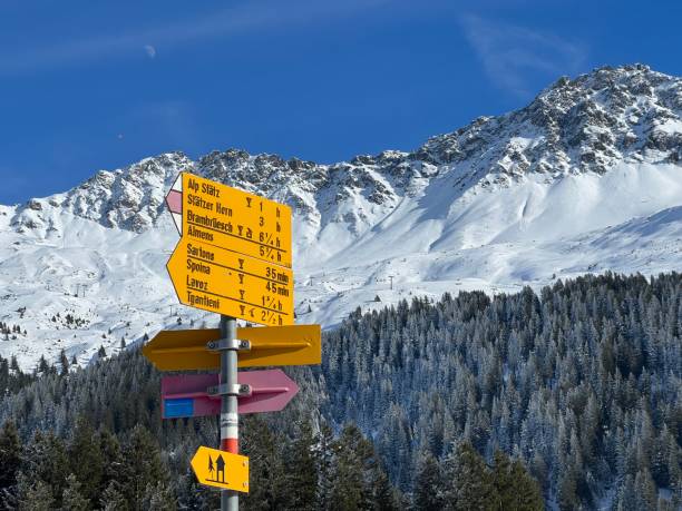 Hiking markings and orientation signs with signposts for navigating in the idyllic winter ambience above the tourist resorts of Valbella and Lenzerheide in the Swiss Alps - Canton of Grisons, Switzerland (Kanton Grubünden, Schweiz) stock photo