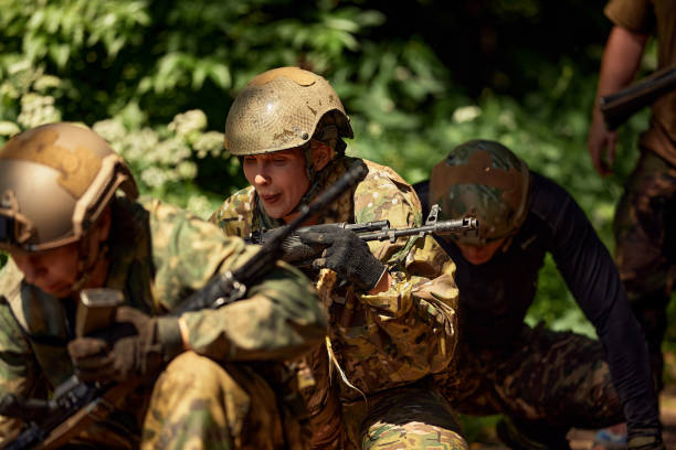 soldiers game on military training ground battle camp. action. operation trainer giving training to military soldiers at boot camp - exercising outdoors group of people military training camp foto e immagini stock