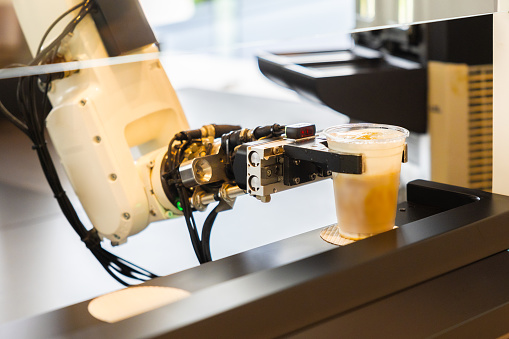 Robot arm serving iced coffee