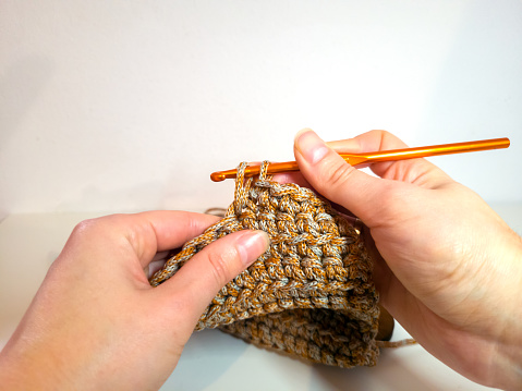 Crochet process with hands and cord