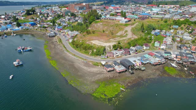 Traditional Buildings Of Castro Chile On Waterway, Chiloe Island, 4K Drone Flyover