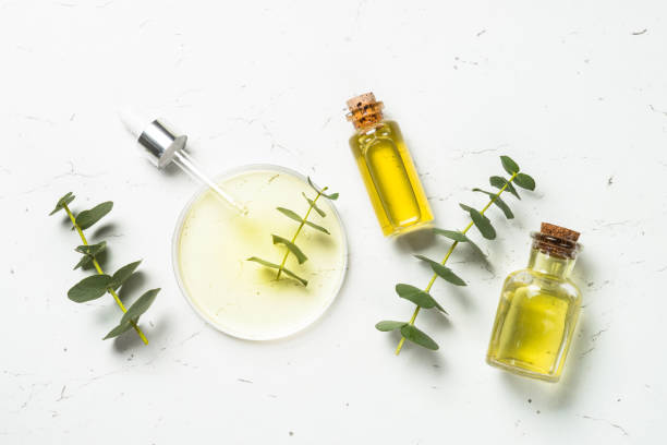 istock Glass petri dish with essential oil at white background. Top view with copy space. 2078048623