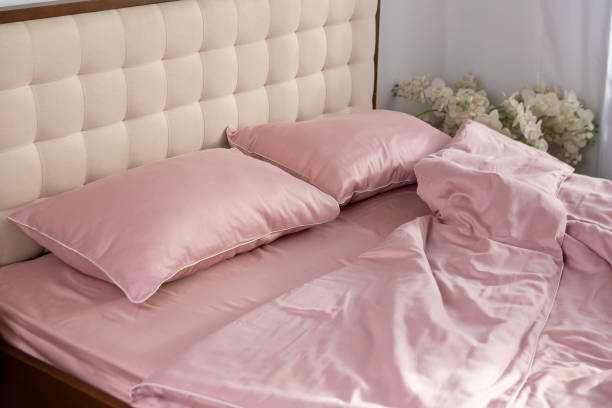 istock pale pink satin bed linen and pillows morning messy 2078055362