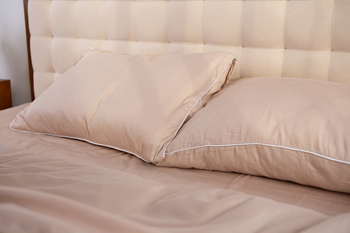 light beige satin bed linen and pillows