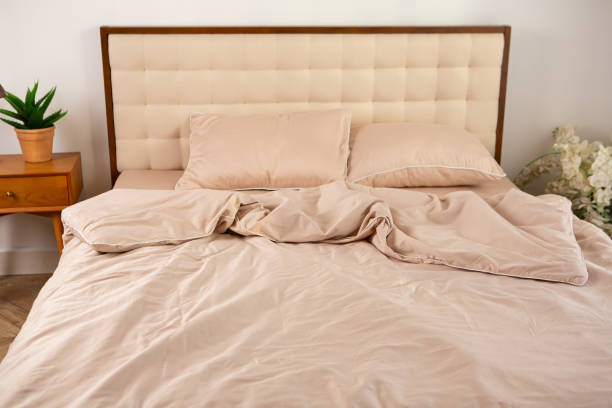 istock light beige satin bed linen and pillows on the bed 2078055880