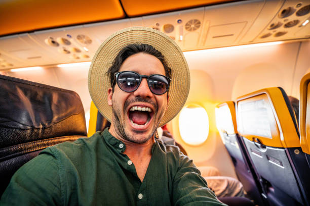 istock Happy young tourist taking selfie picture on a plane 2078062228