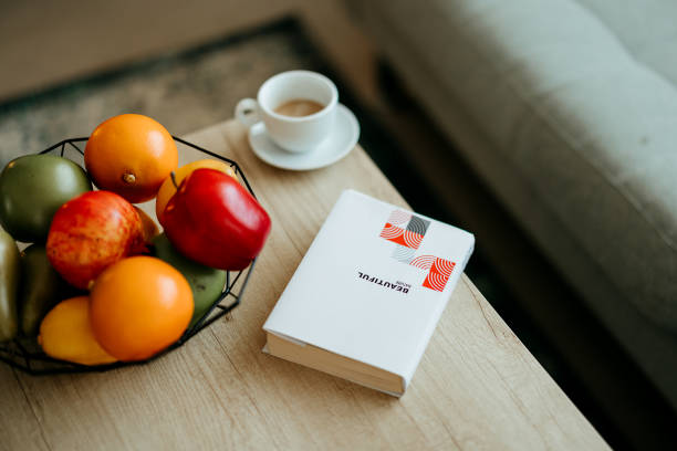 Coffee, book and fruit on the table