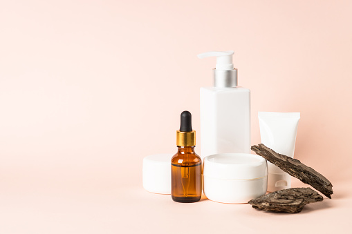 Natural cosmetic concept. Skincare product with tree bark at pastel background. Biophilic design.