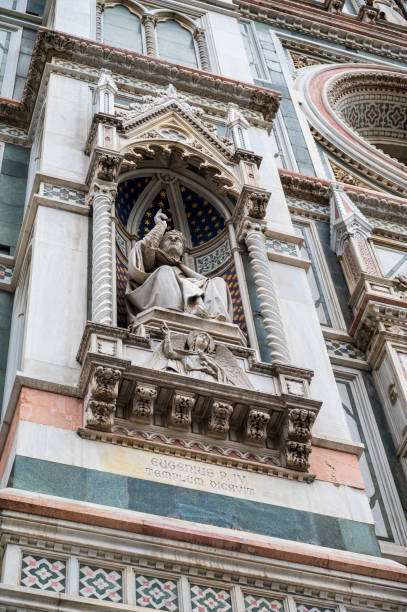Statue and historic facade of the cathedral in Florence