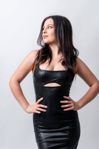 istock Model posing looking away wearing black long dress 2078097394