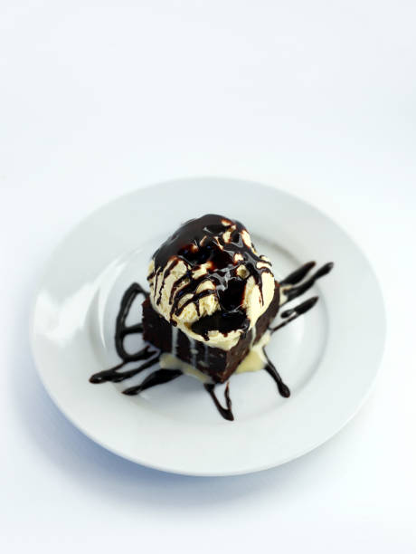 istock brownie with vanilla ice cream and chocolate cream 2078105886