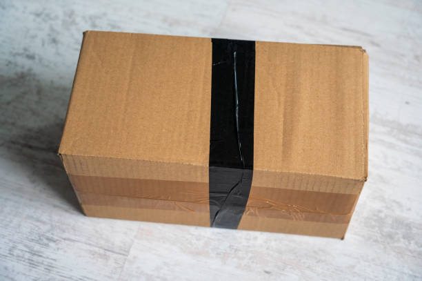 istock Cardboard box glued with black adhesive tape. 2078106944