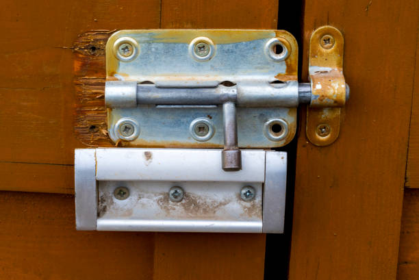 istock Old metal lock and handle on a wooden door. 2078128614