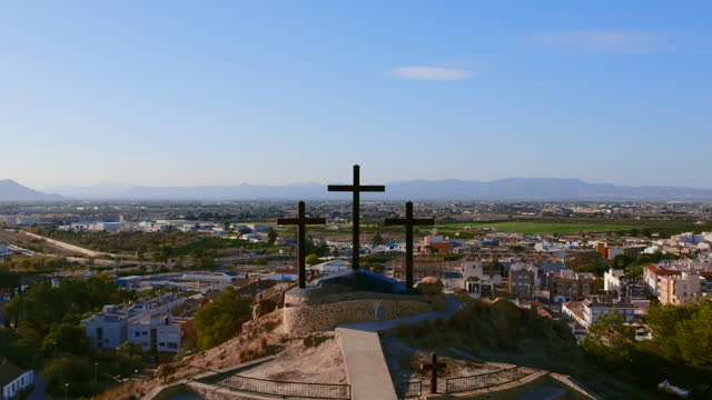 Monte Calvario and three crosses against townscape