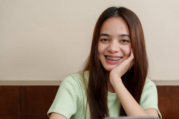 istock Joyous young Asian lady with a subtle smile looks at tablet, serene study scene with warm home tones. Pleased student with tablet, soft natural light complements tranquil studying environment. 2078142344