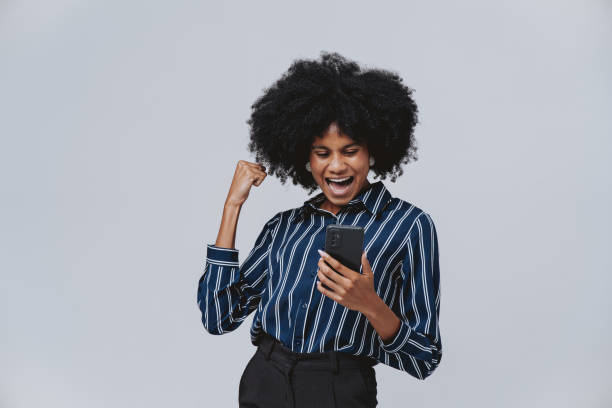 istock Portrait of an ecstatic woman using smartphone 2078153279