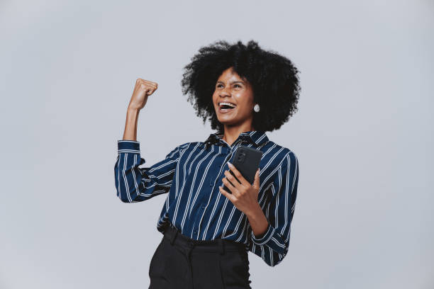 istock Portrait of an ecstatic woman using smartphone 2078153280