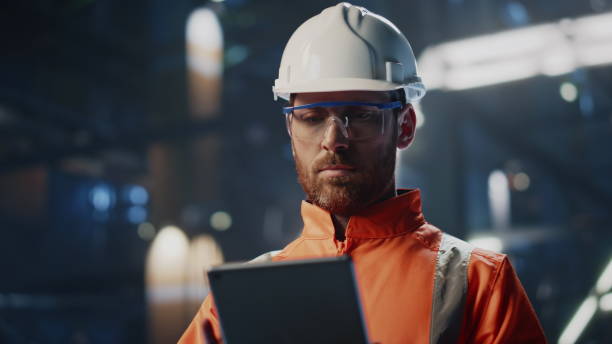 istock Skilled technician inspecting production industrial facility with tablet closeup 2078167318