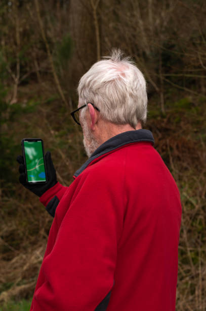 istock Senior man checking a map app on his mobile phone 2078172071