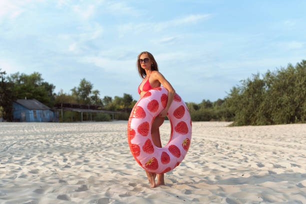 istock Young woman relaxing on the beach 2078175799