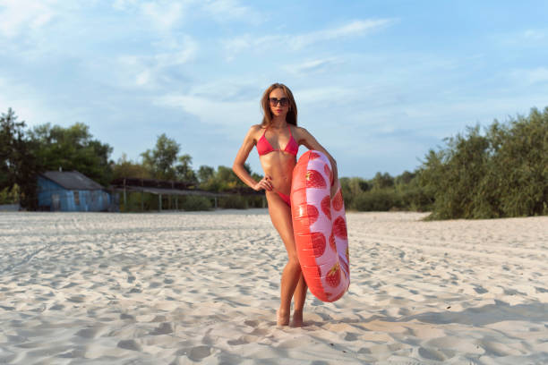 istock Young woman relaxing on the beach 2078176450
