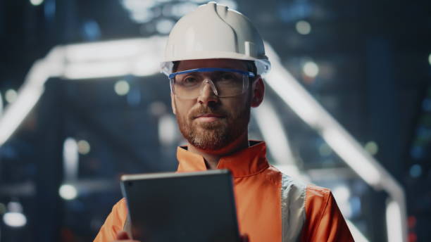 istock Satisfied factory inspector working tablet standing at production close up. 2078180072