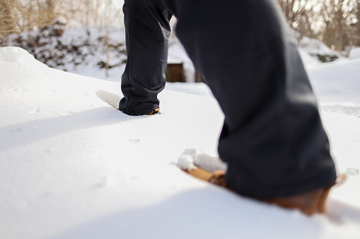 Close-up of a woman struggling to walk in the snow