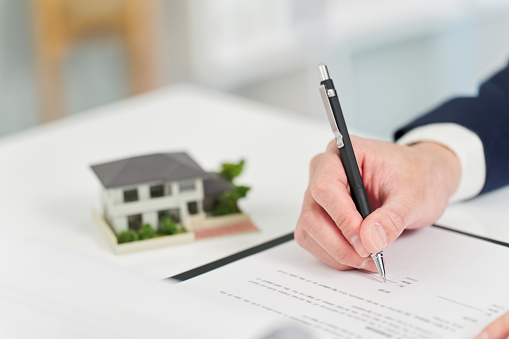 Businessman signing a real estate contract