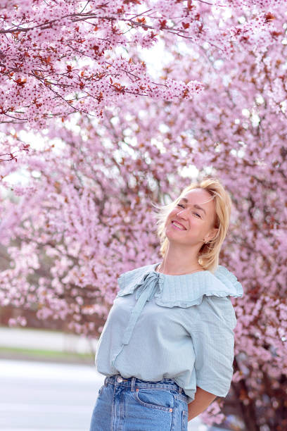 istock girl among beautiful cherry blossoms in full bloom 2078183875
