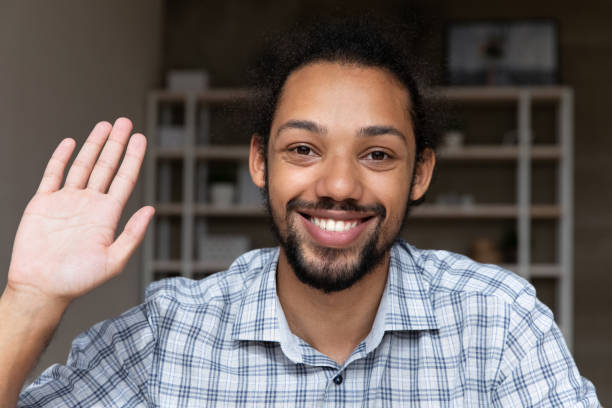 istock Closeup smiling African guy wave hand start videocall webcam view 2078191212