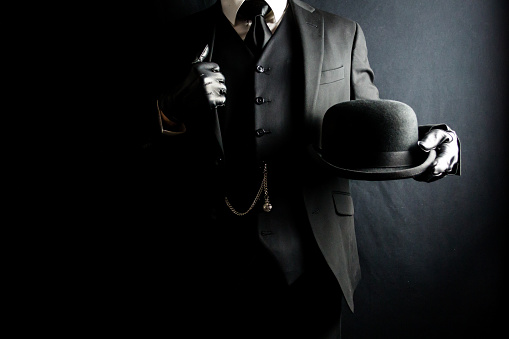 English Gentleman in Suit and Leather Gloves Holding Bowler Hat