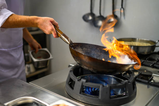 istock Chef holding a flaming wok 2078241425