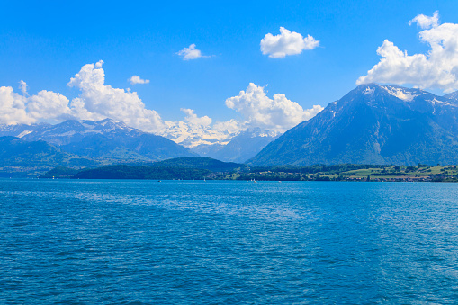 View of the Annecy lake surrounded by beautiful mountains in Annecy, France