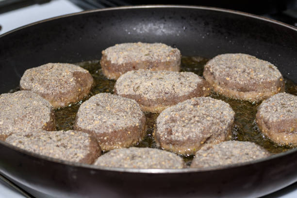 minced wild boar cutlets fried in rapeseed oil in a hot pan