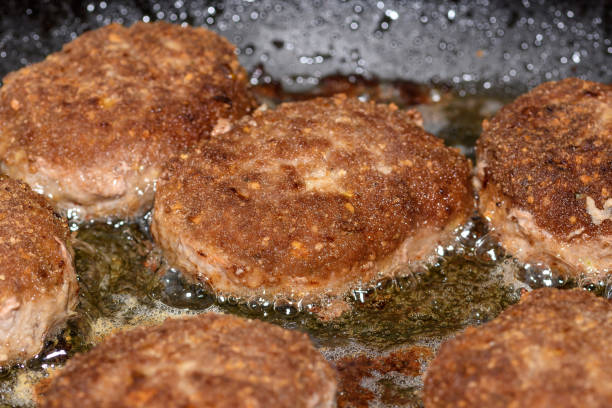 Minced cutlets fried in a pan in the kitchen isolated