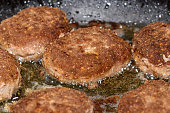 Minced cutlets are fried in a pan in oil, close up
